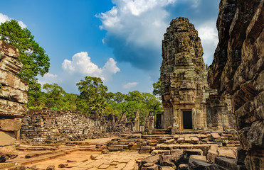 Fototapeta premium Prasat Bayon with smiling stone faces is the central temple of Angkor Thom Complex, Siem Reap, Cambodia. Ancient Khmer architecture and famous Cambodian landmark, World Heritage.
