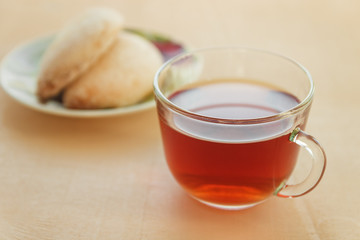 Cup of tea with cookies on table close-up