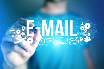 Concept of man holding futuristic interface with e-mail title and multimedia icons flying all around - Internet concept