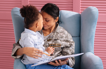 Emotional attentive mother complimenting her daughters essay