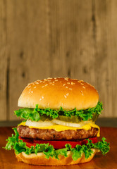 Classic deluxe cheeseburger with lettuce, onions, tomato and pickles