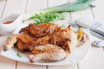 Roasted whole chicken on dish with cutlery