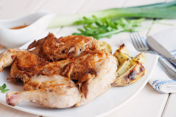 Roasted whole chicken on dish with cutlery
