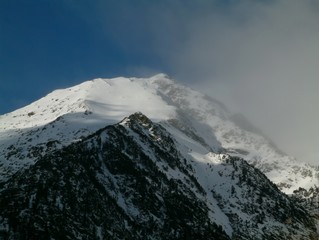 Snowy mountain peaks in a beautiful winter day