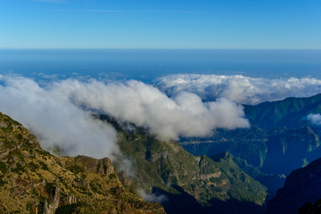 Fototapeta na wymiar Clouds and peaks on top of the highest mountain of Madeira Pico Ruivo, Portugal