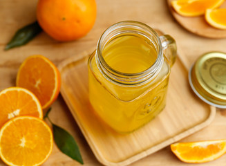 Orange juice and oranges on retro wooden desk