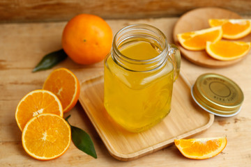 Fototapeta na wymiar Orange juice and oranges on retro wooden desk