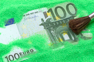 Banknote one hundred euros in the green sand