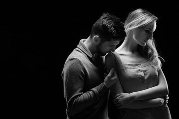 Bofriend kissing his girlfriend on her shoulder