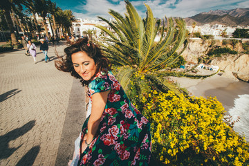 Girl in wonderful dress in Spain at the sea