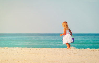 cute little girl walk on beach