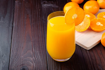 Orange juice on wooden background