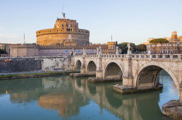 Obraz premium Castle of Holy Angel (Castel Sant Angelo) and Holy Angel Bridge over the Tiber River in Rome at sunset. Italy, Europe 