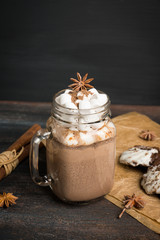 Hot chocolate with marshmallow on the wooden background. Shallow depth of field.