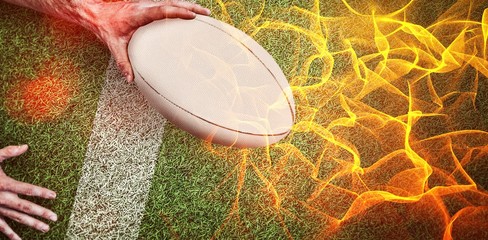 Composite image of a man holding rugby ball