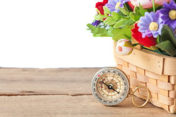 compass with flower plant basket on wood floor