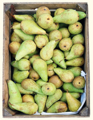 Street sale of fresh green pears in wooden boxe.