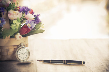 pocket watch and flower plant in basket