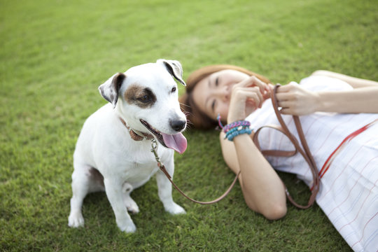 Young woman relaxing with a dog