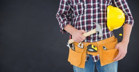 Composite image of Carpenter with hammer against blackboard