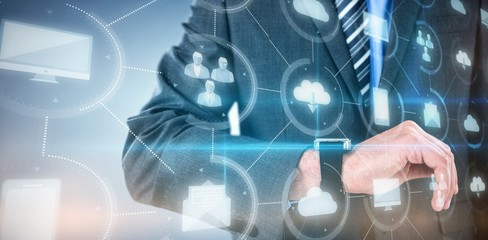 Composite image of businessman checking smart watch 