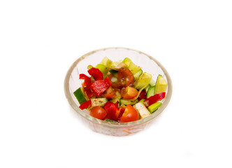 Vegetable salad pepper tomato cucumber in transparent bowl on white background