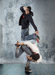 Fototapeta na wymiar Two man break dancing on wall background
