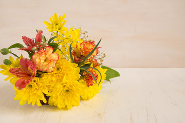 Composition of  bright flowers on a wooden table