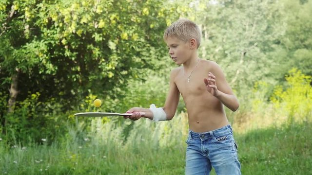 Young handsome boy playing racket ball in outdoor in slow motion. 1920x1080