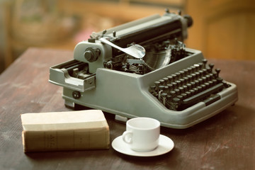 Typewriter, cup, book