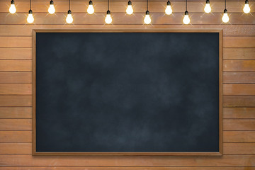 Empty room with chalkboard and white wood wall with bulb lights lamp. nice brick show room with spotlights. Concept business, drawing, ideas, education, art.
