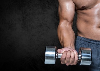 Man performing dumbbell curl exercise against black background