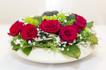 Festive floral arrangements of red roses.