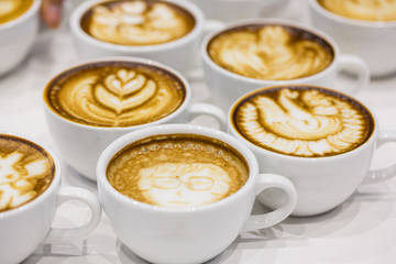 art latte on a cappuccino coffe cup