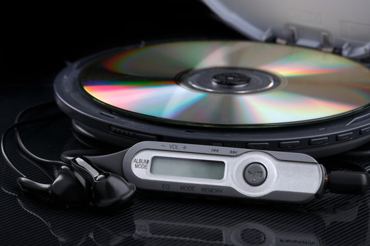 Opened CD audio player with disc inside on black background
