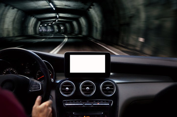 Driving hands on steering wheel. Man driving through the tunnel. Front part of car with navigation...