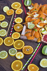 Assorted cut citrus fruits on wooden background