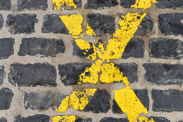  yellow cross / Yellow cross on black paving stones