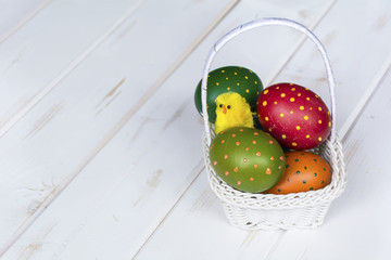beautiful easter eggs with dots in a white basket 