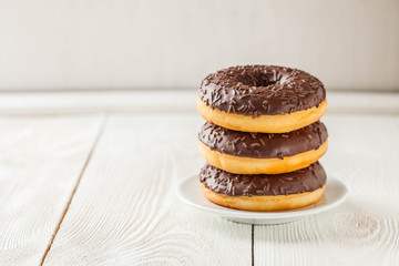 Chocolate donuts on a wooden background, Copyspace