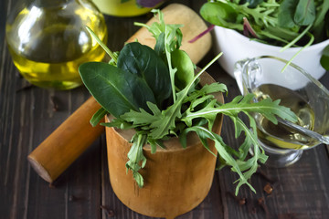 Bowl of fresh mixed salad on wooden background