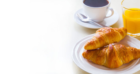 croissant with coffee and orange juice on a white background
