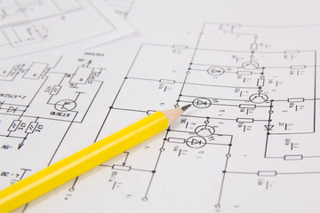 Electronics and Engineering. Pencil on printed drawings of electrical circuits