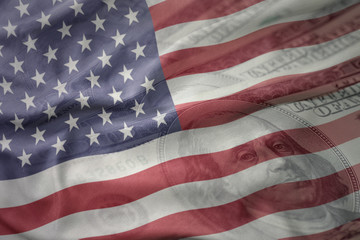 colorful waving national flag of united states of america on a american dollar money background....