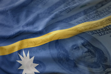 colorful waving national flag of Nauru on a american dollar money background. finance concept