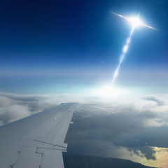 Ufo flies near airplane in dark blue sky