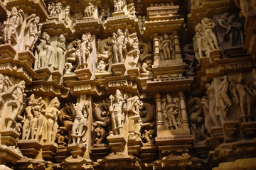 Fototapeta na wymiar Detail of artwork at the Khajuraho temple on India