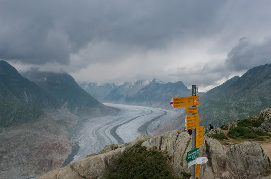 Signpost for hikers with the mighty Aletsh Glacier in the background, Bettmeralp, Switzerland.