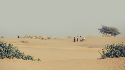 Group of Men Walking through the Desert in India