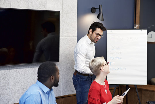Caucasian businessman giving a presentation to colleagues in a meeting